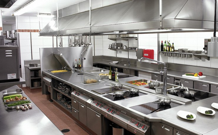 stainless commercial kitchen with exhaust hood